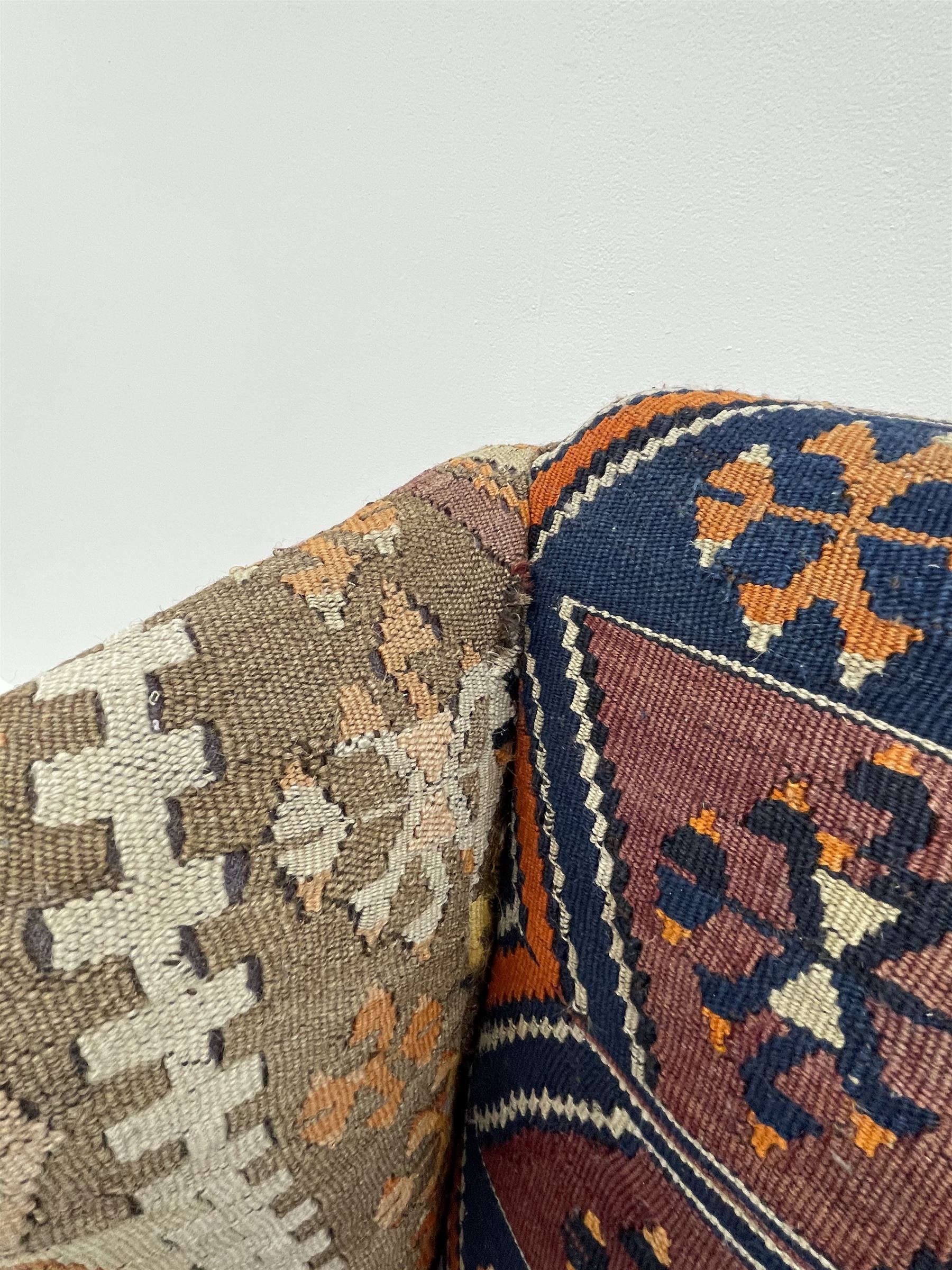 Late 20th century beech framed wingback armchair, sprung seat and back upholstered in kilim cover, acanthus carved cabriole supports with ball and claw feet