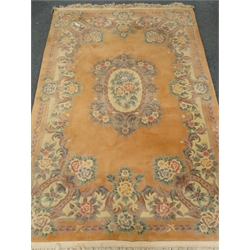  Chinese pink ground woollen rug, central floral medallion, 276cm x 184cm  