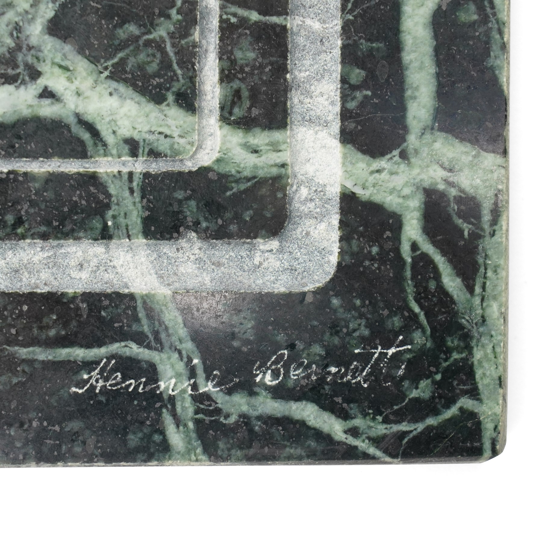 Hennie Bernett (20th/21st century): Inuit mother carrying her child in an amauti, bas-relief in verde marble, signed 'Hennie Bernett' with sculptor's sticker on the rear, 38.2cm x 38cm 