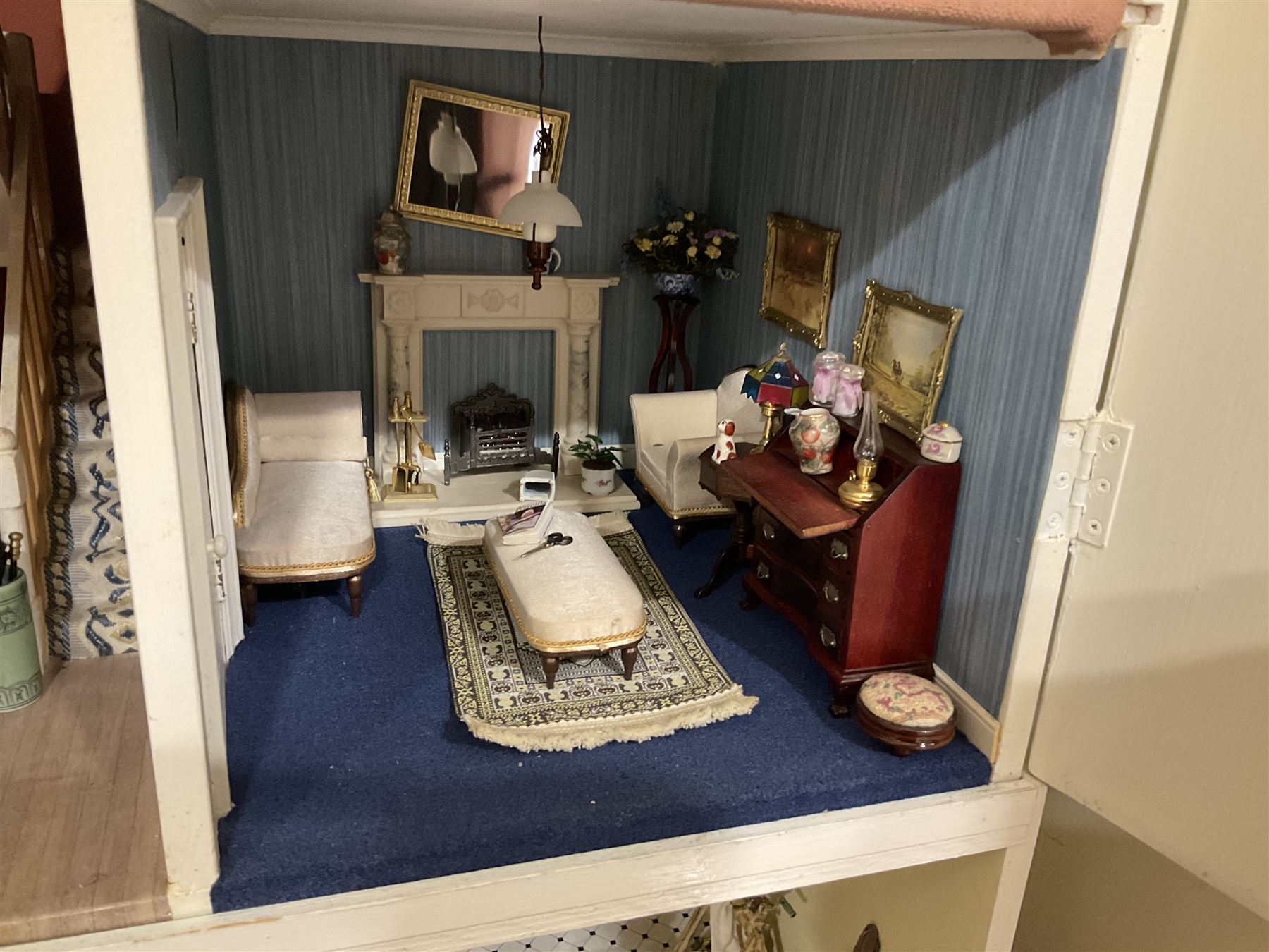 Honeychurch kit-built large wooden dolls house as a 19th century style double fronted four storey town house; with stucco finish under a pitched roof with Palladian style pediment and simulated tiles; protruding front courtyard with railings, street light and steps giving access to two fully furnished basement rooms; central door with Ionic columns and entablature; double hinged front facade opening to reveal a fully furnished interior with hall, stairs and landings and two rooms on each floor; wired for electric wiring W67cm H102cm D58cm