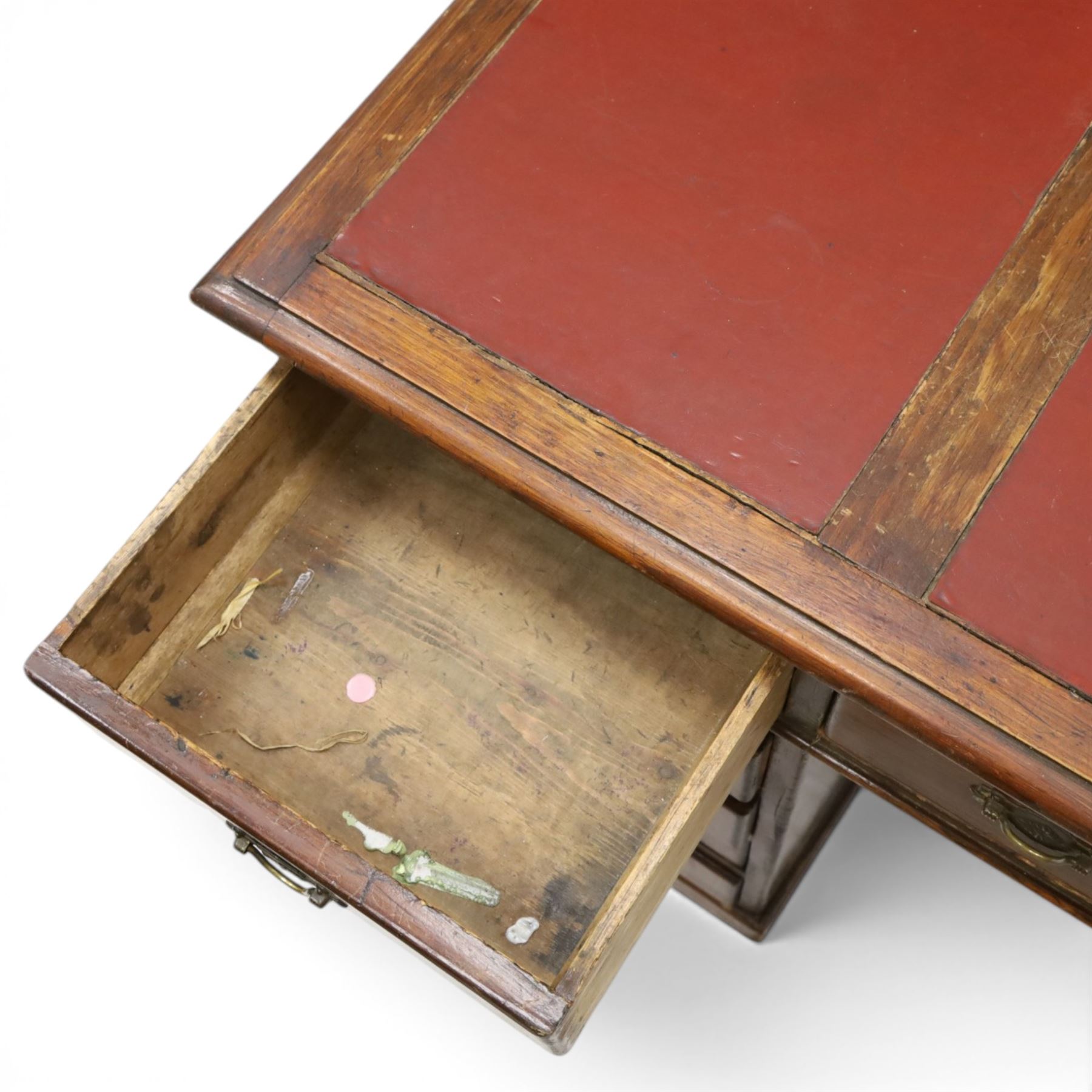 Late 19th century twin-pedestal desk, red leather inset top over an assortment of eleven drawers, on plinth base (W126cm D65cm H77cm); with Edwardian oak framed Captains swivel desk chair, of tub shaped form with spindle back supports (W60cm H89cm)