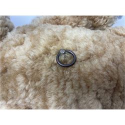 1950s sheepskin plush covered teddy bear with musical movement, the revolving head with applied eyes, leather nose and stitched mouth, jointed limbs with leather pads H50cm