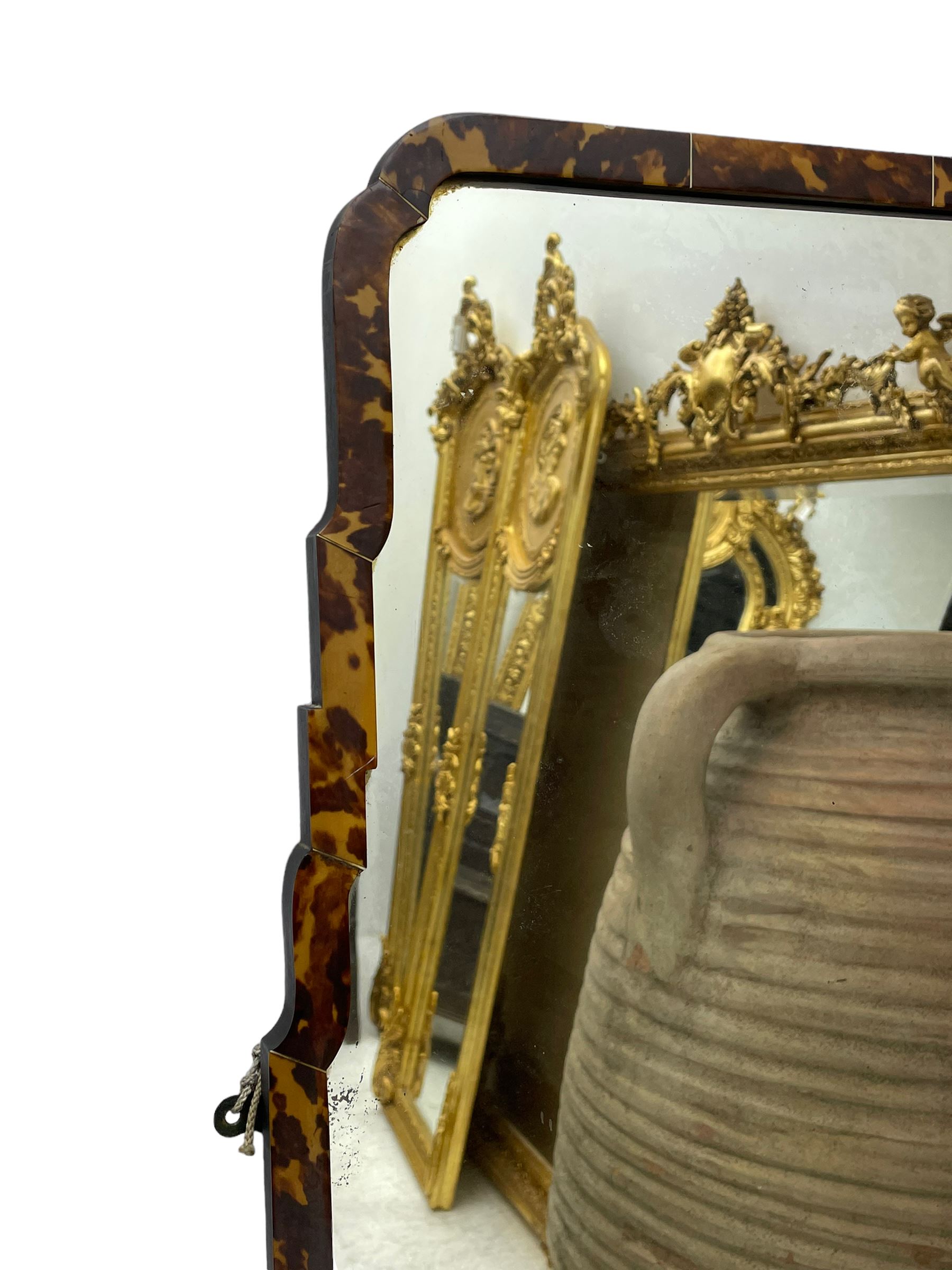 Early 20th century wall hanging tortoise shell framed mirror, of rectangular form, the upper half of the frame shaped and stepped surrounding a plain mirror plate