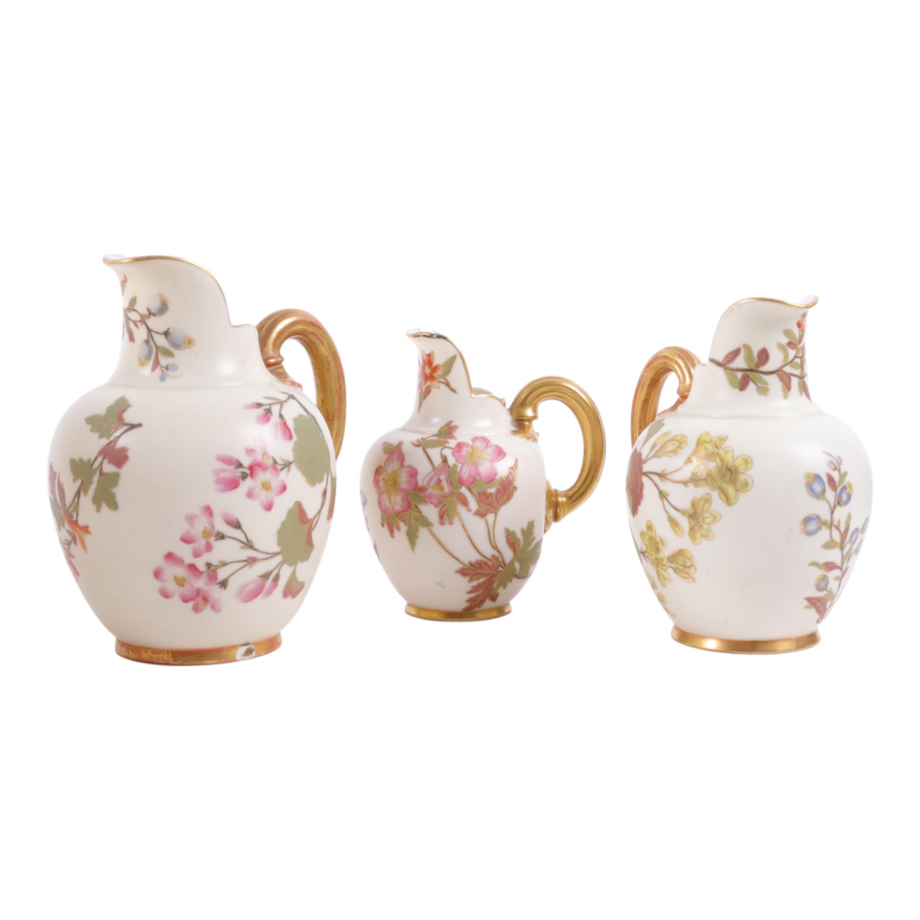 Five Royal Worcester Blush Ivory jugs, shape 1094, each decorated with floral sprigs and with gilt handles , all with puce mark to base, tallest H18cm