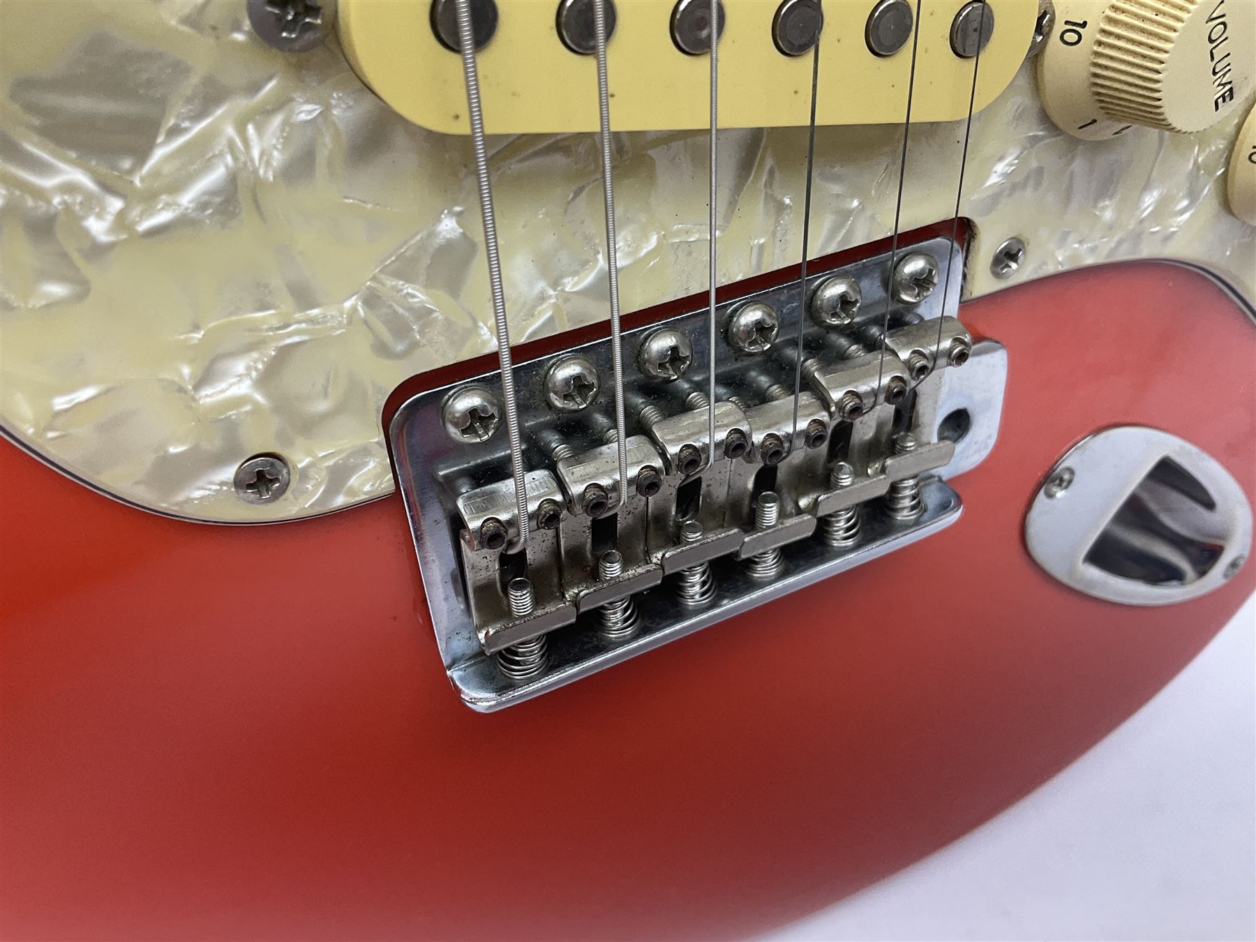 Japanese Squier Fender 'Hank Marvin' Stratocaster electric guitar, c1992, in Fiesta red with tremolo arm and facsimile signature decal; serial no.L037281, L98cm; in hard carrying case.