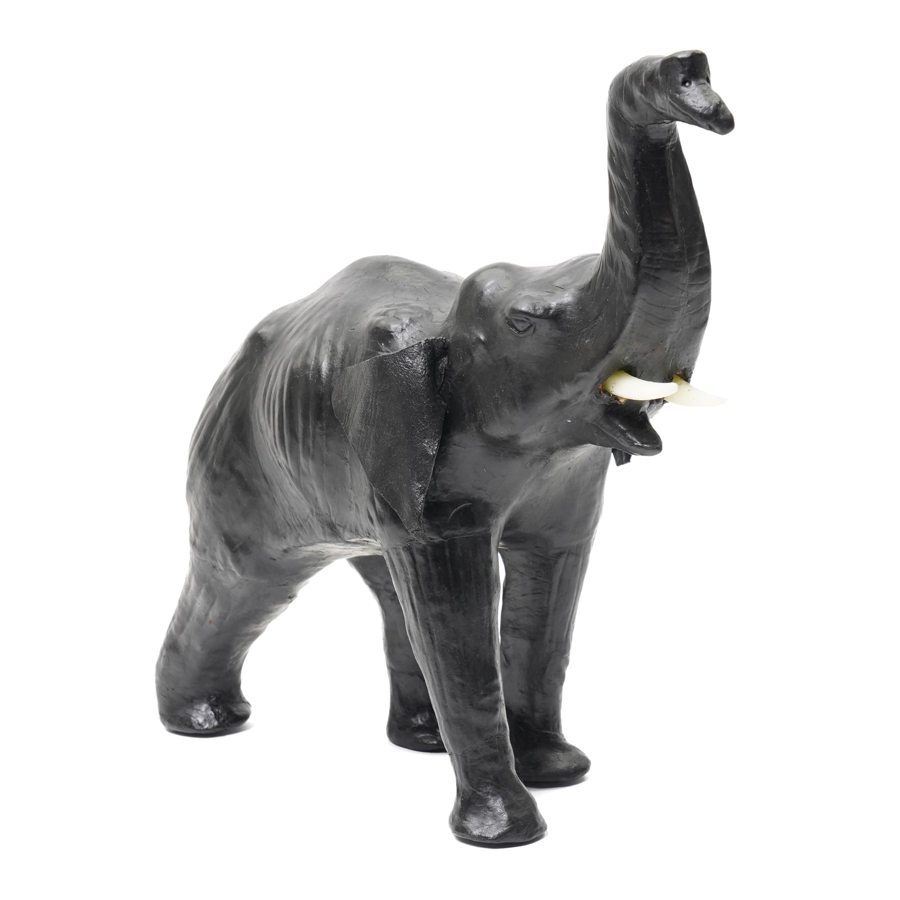 In the style of Liberty & Co - pair of 20th century ebonised papier mache elephants 