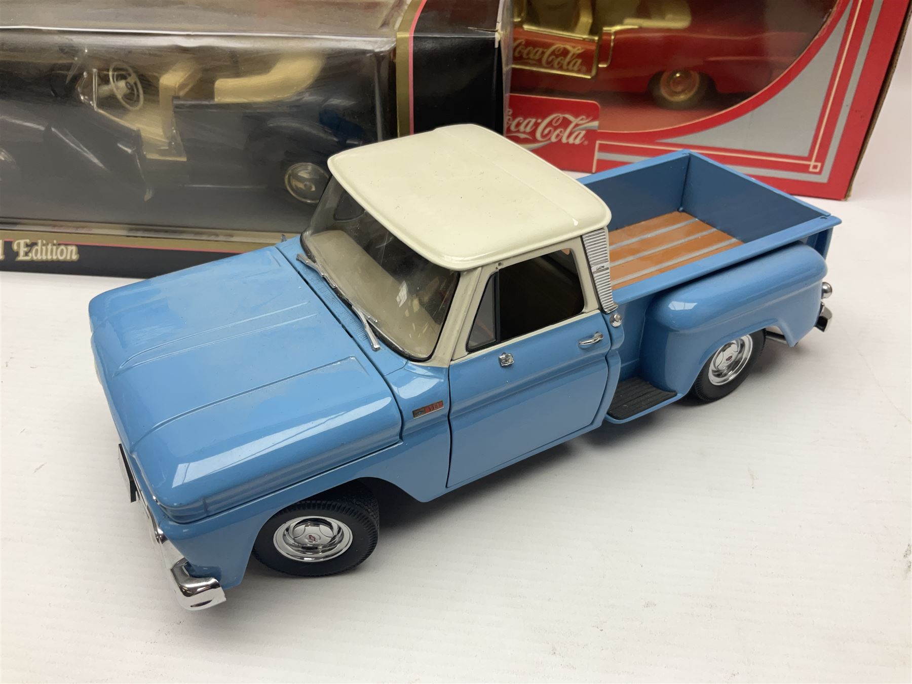 Seven 1:18 scale die-cast models by Ertl, Road legends, Maisto, Solido etc including two Coca Cola promotional vehicles; five boxed (7)