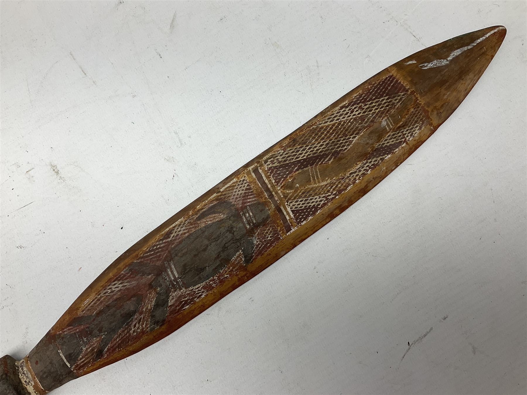 Australian Aboriginal shield, carved with Kangaroo and Emu, 74.5cm; Spear painted with aquatic creatures 78cm, and Spear thrower 81cm (3)