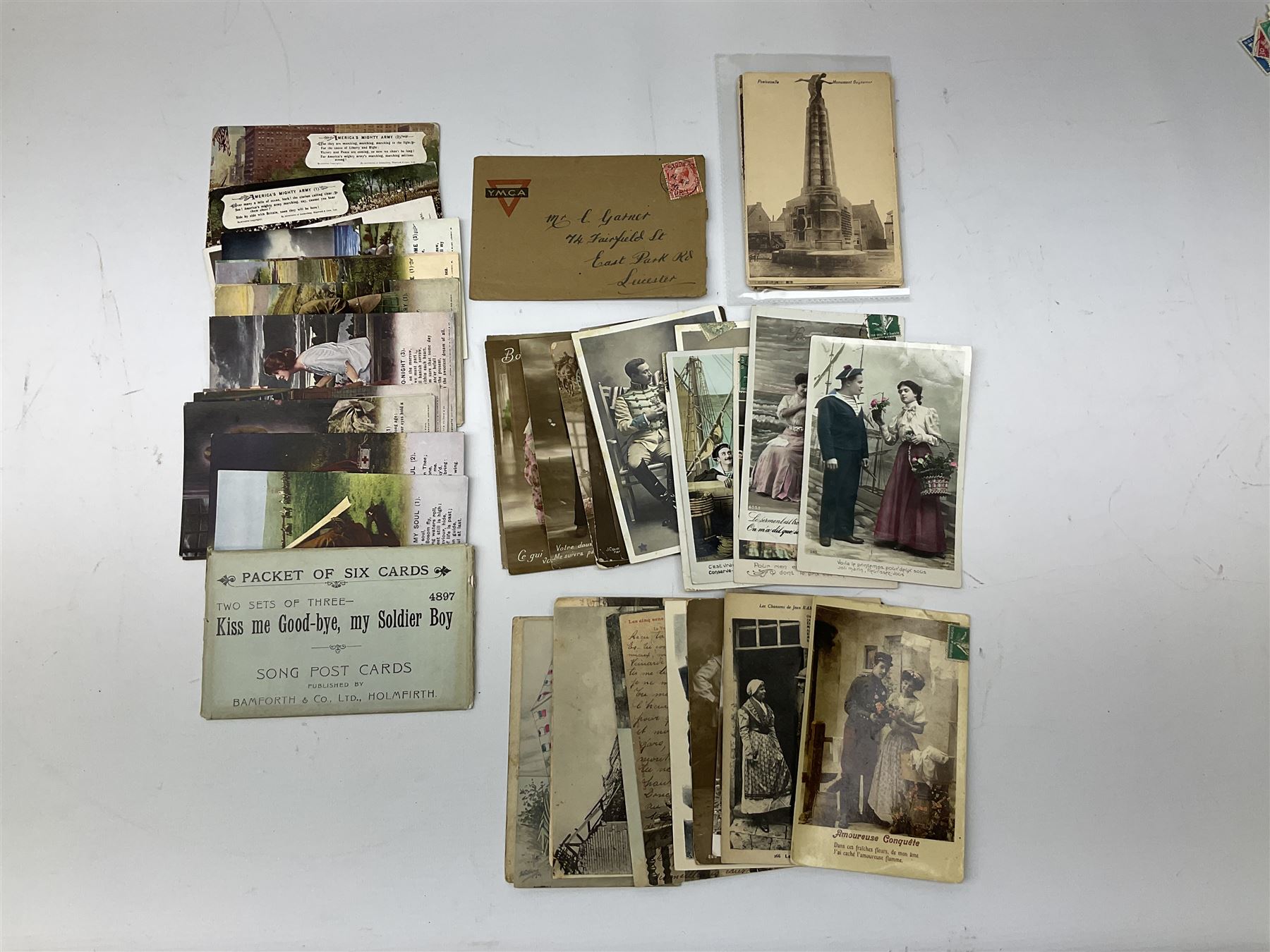 Comic postcards including Bamforth and Quip examples together with WW1 postcards, a collection of world stamps including examples from China, and other ephemera 