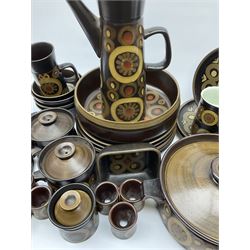 Denby Arabesque pattern tea and dinner wares, comprising large serving bowl,  five dinner plates, three side plates, four twin handled bowls and covers, one bowl and cover, four bowls, salt and pepper shaker, pan with lid, six egg cups, small serving dish, coffee pot, water jug, milk jug, jug with handle,  two sucriers and covers, four tea cups and one coffee