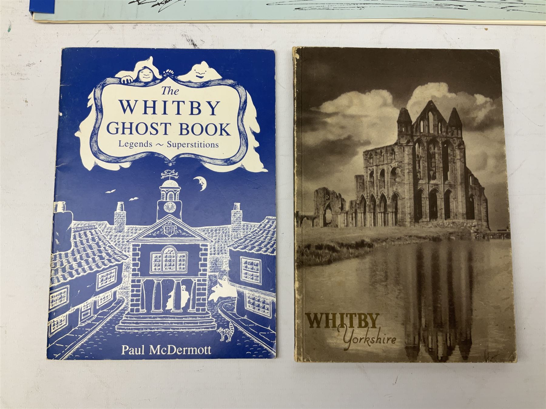 Quantity of books and postcards predominantly of Whitby interest including Hornes' Guide to Whitby 1890 and Hornes' Tourist map of Whitby, A Holiday Tour in and Around Whitby by H.S. Forman 1896 etc