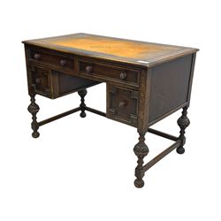 Early 20th century Jacobean design oak desk, with rectangular top inset with worn tooled leather, two frieze drawers over pedestals each fitted with a pair of panelled drawers, turned handles, on carved and fluted tapering legs united by stretchers 