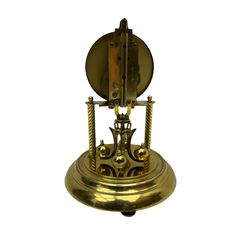 A mid-20th century “Bentima” 400-day anniversary torsion clock with a 7” circular brass base and unenclosed movement supported on two twisted columns, with a white dial gilt numerals and baton hands, four-ball rotary pendulum and glass dome. 

