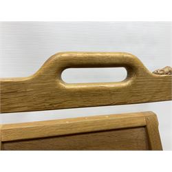 Mouseman - oak magazine rack, the top rail pierced with handle and carved with mouse signature, octagonal supports with two panelled and splayed sides, on sledge feet, by the workshop of Robert Thompson, Kilburn 