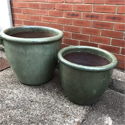 Two large graduating green glazed terracotta pots, D50cm (max)