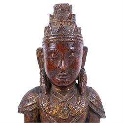 Late 18th century, carved wooden buddha, seated cross legged on a lotus base, with traces of original painted decoration, H35cm 
