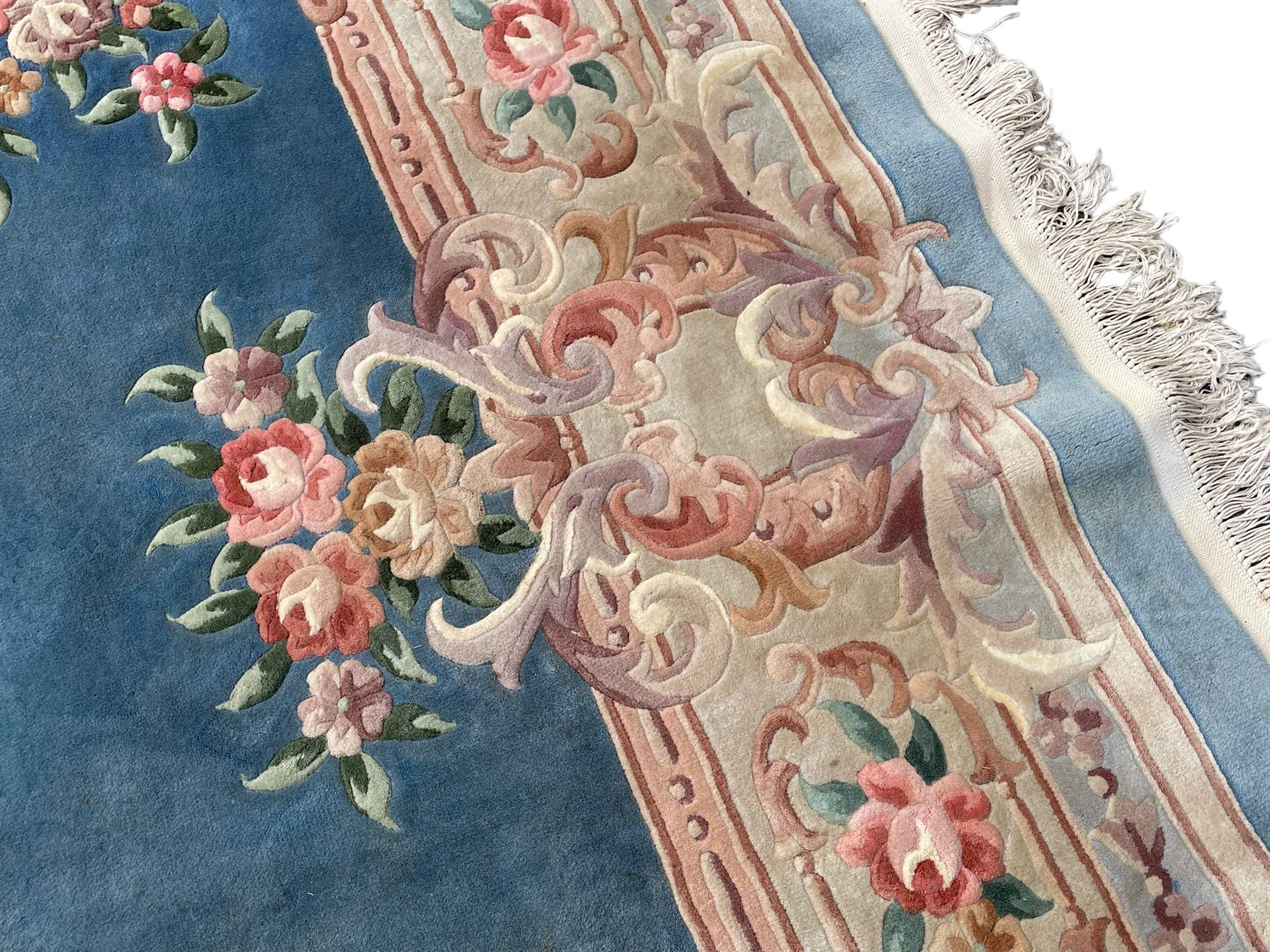 Large Chinese blue ground woollen carpet, overall floral design, central oval medallion surrounded by scrolling floral decoration, wide border with decorated with floral bouquets 