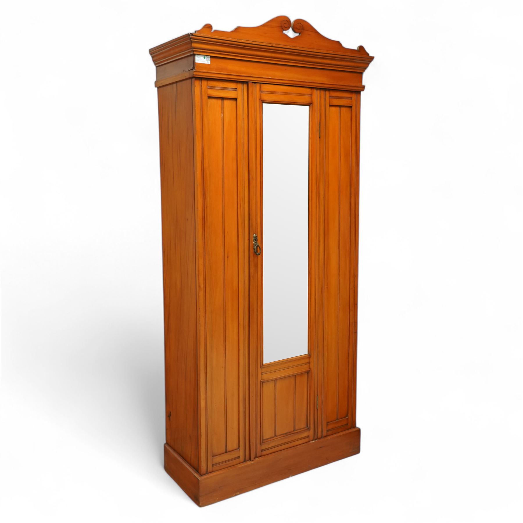 Early 20th century satin walnut wardrobe and dressing table, including a tall single wardrobe with mirrored door beneath a shaped cornice and moulded pediment, (H 205cm, D 39cm, W 91cm) and a matching dressing chest with glazed lift-top compartment and three drawers, mirror supported by scrolled uprights with flanking open shelves (H 170cm, D 45cm, W 84cm)