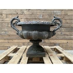 Victorian design ornate cast iron centrepiece urn, featuring two handles, raised on footed base