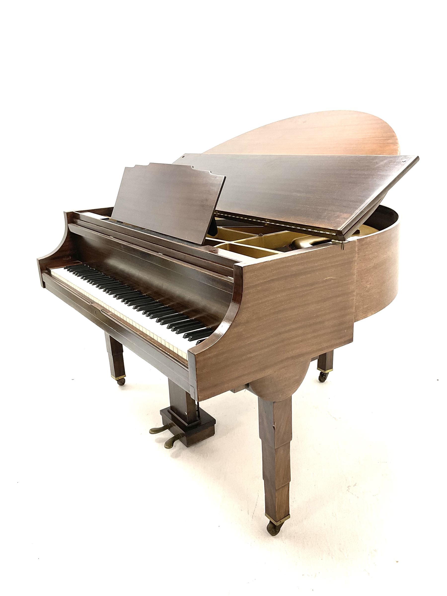 Early 20th century mahogany cased Strohmenger London baby grand piano, demi lune shape, over strung cast iron framed, raised on square tapered supports and castors 