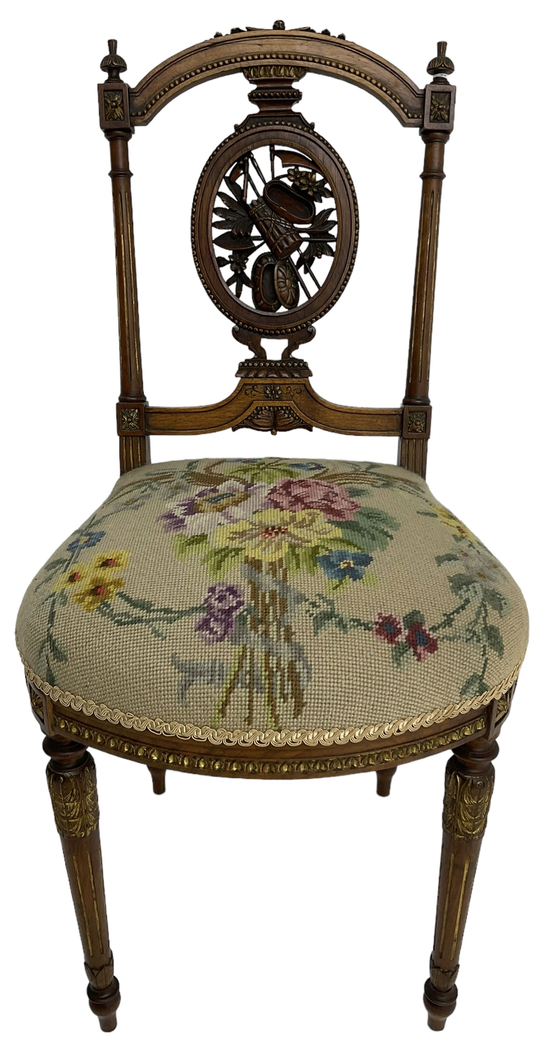 Late Victorian walnut side chair, arched cresting rail over carved and pierced splat depicting baskets and foliage, floral needle work upholstered seat, on acanthus carved and fluted turned supports