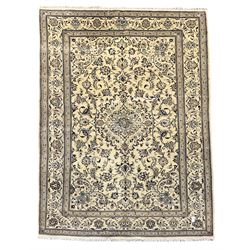 Central Persian Nain rug, wool with silk inlay, ivory ground decorated with scrolling and interlaced branch with stylised plant motifs, central floral medallion, triple band border with repeating design