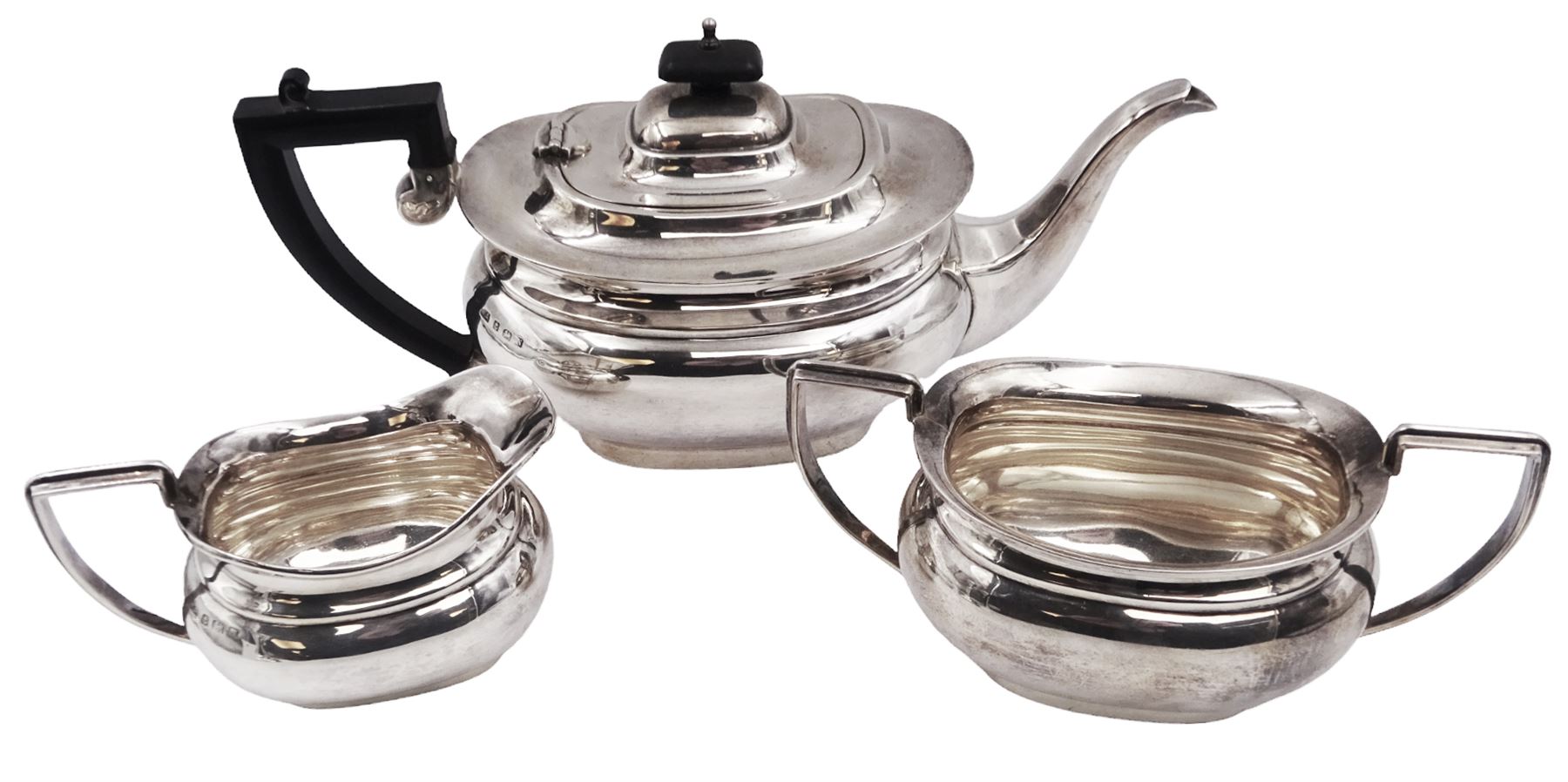 1930s three piece silver tea service, comprising teapot, milk jug and twin handled open sucrier, of oval bellied form, the teapot with Bakelite type handle and finial, hallmarked William Adams Ltd, Birmingham 1937, teapot H16cm