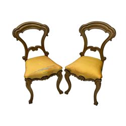 Pair of Victorian walnut side chairs, shaped cresting rail carved with acanthus leaves, overstuffed upholstered seats with stud band, on cabriole supports with scroll carved terminals