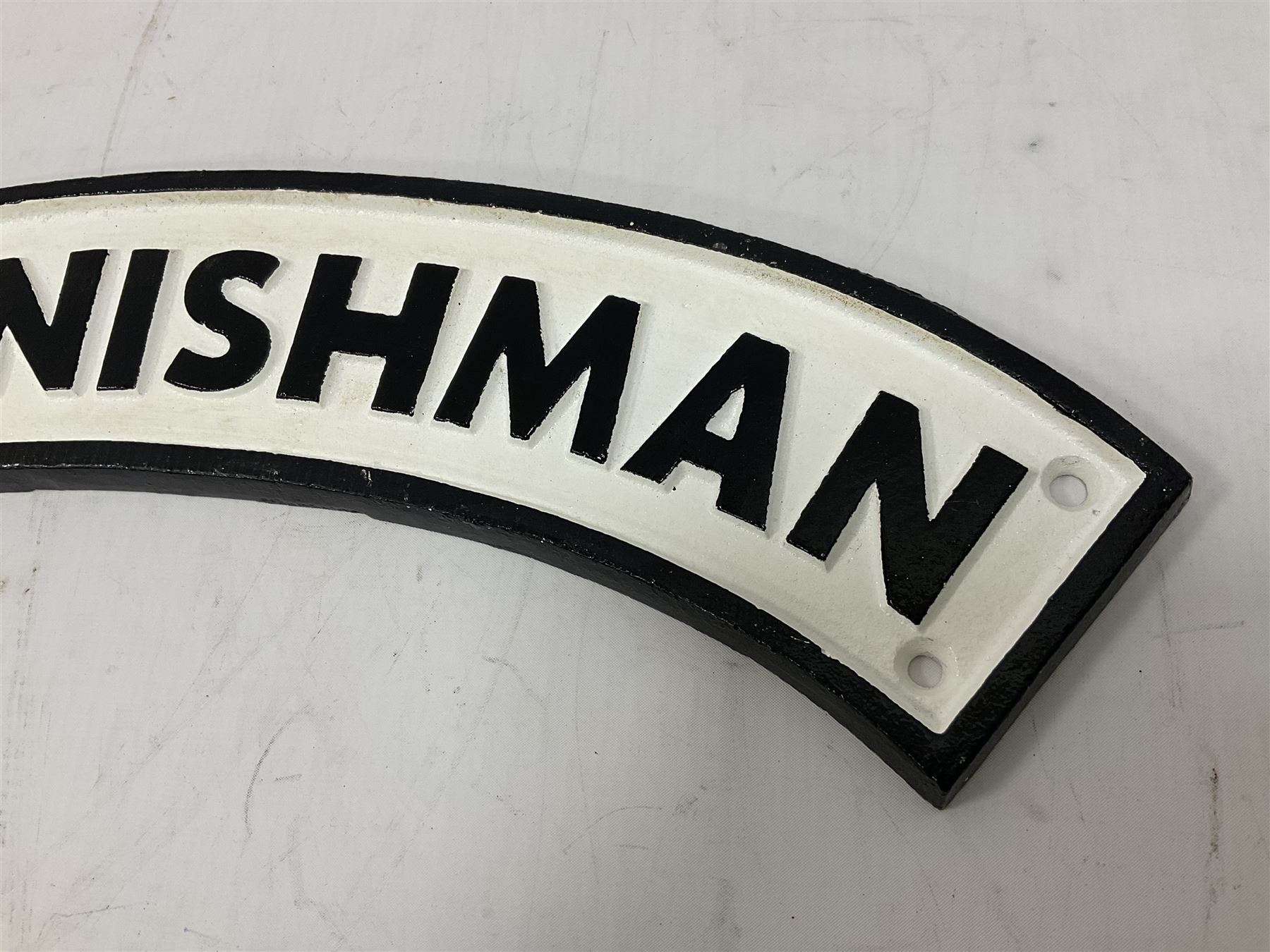 Arched cast iron Cornishman sign, L48cm