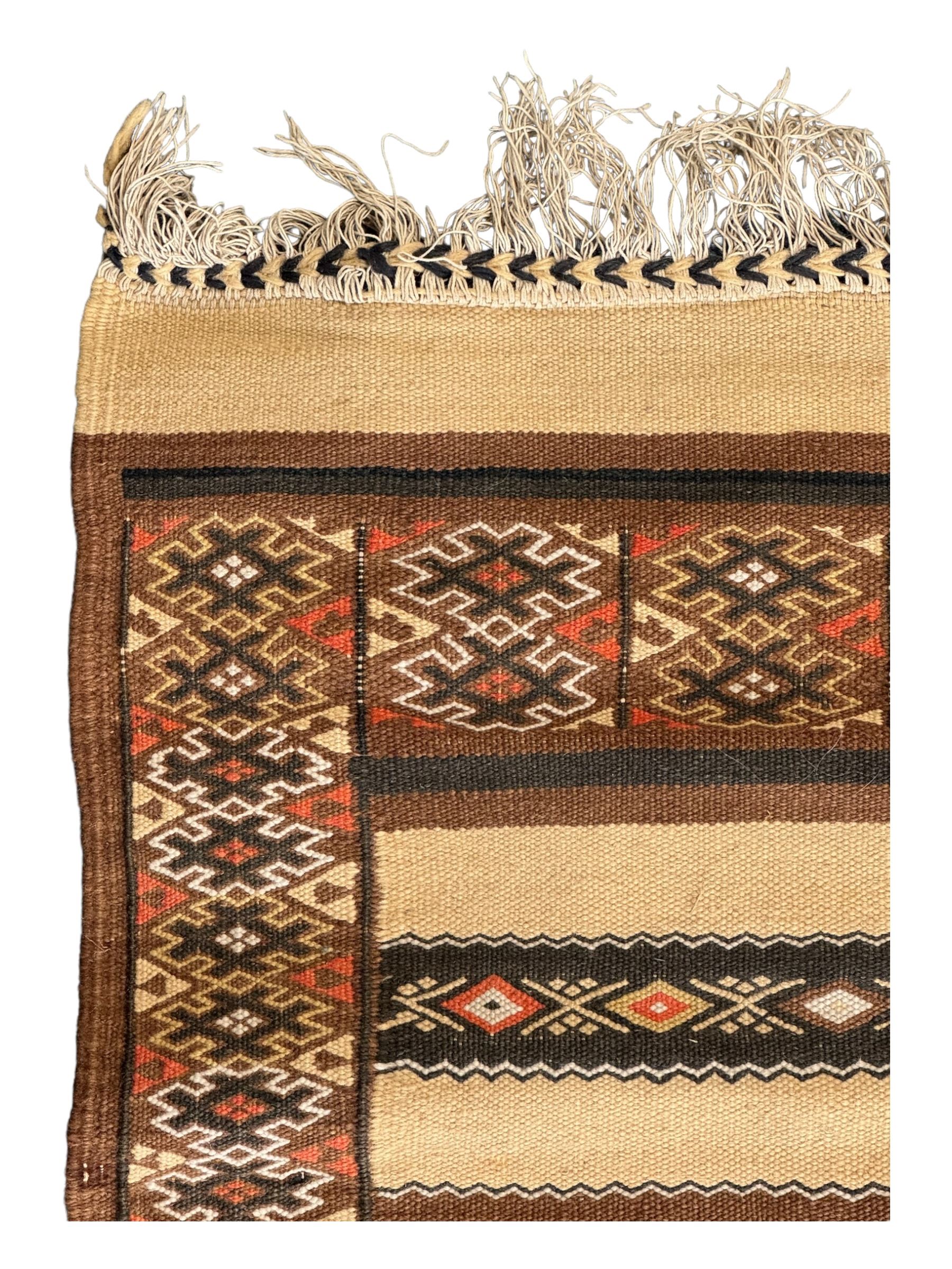 Turkish Kilim ground rug, the field with alternating horizontal bands of geometric patterns, bordered by repeating diamond motifs (145cm x 242cm); Turkish red ground rug, the field with three octagonal medallions (113cm x 172cm) (2)