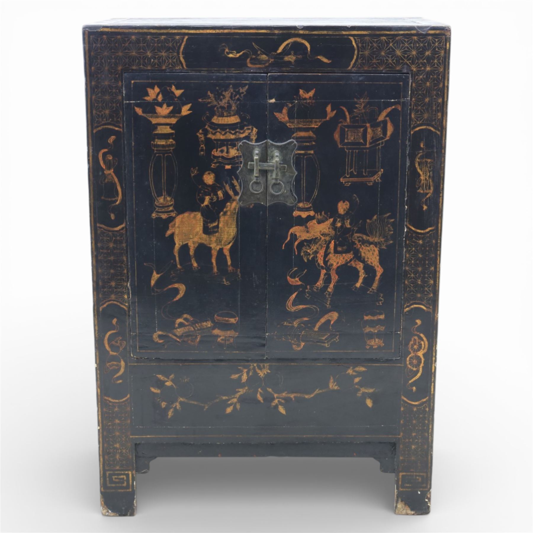 19th century Chinese black lacquer marriage cabinet, rectangular form, twin cupboard doors painted with gilt chinoiserie scenes depicting mounted figures, ritual urns and symbolic objects within patterned borders, central shaped metal lock plate with twin drop handles, lower section decorated with fruiting sprays, standing on stile supports