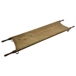 WW1 British casualty stretcher with iron mounted pitch pine sides and canvas base; stamped 'HL1917' and L7 with broad arrow in a triangle L236cm ( reputedly recovered from a barn at Bapaume on The Somme)