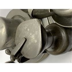 Collection of 18th and 19th century pewter, comprising two chargers, eight large plates, twenty six smaller plates, two bowls, three lidded measures, two jugs, tappit hen, and tankard, the plates with various marks and touch marks, including pseudo 'hallmarks', largest charger 37cm, large plates D30cm, smaller plates D24.5cm, tappit hen H26.5cm