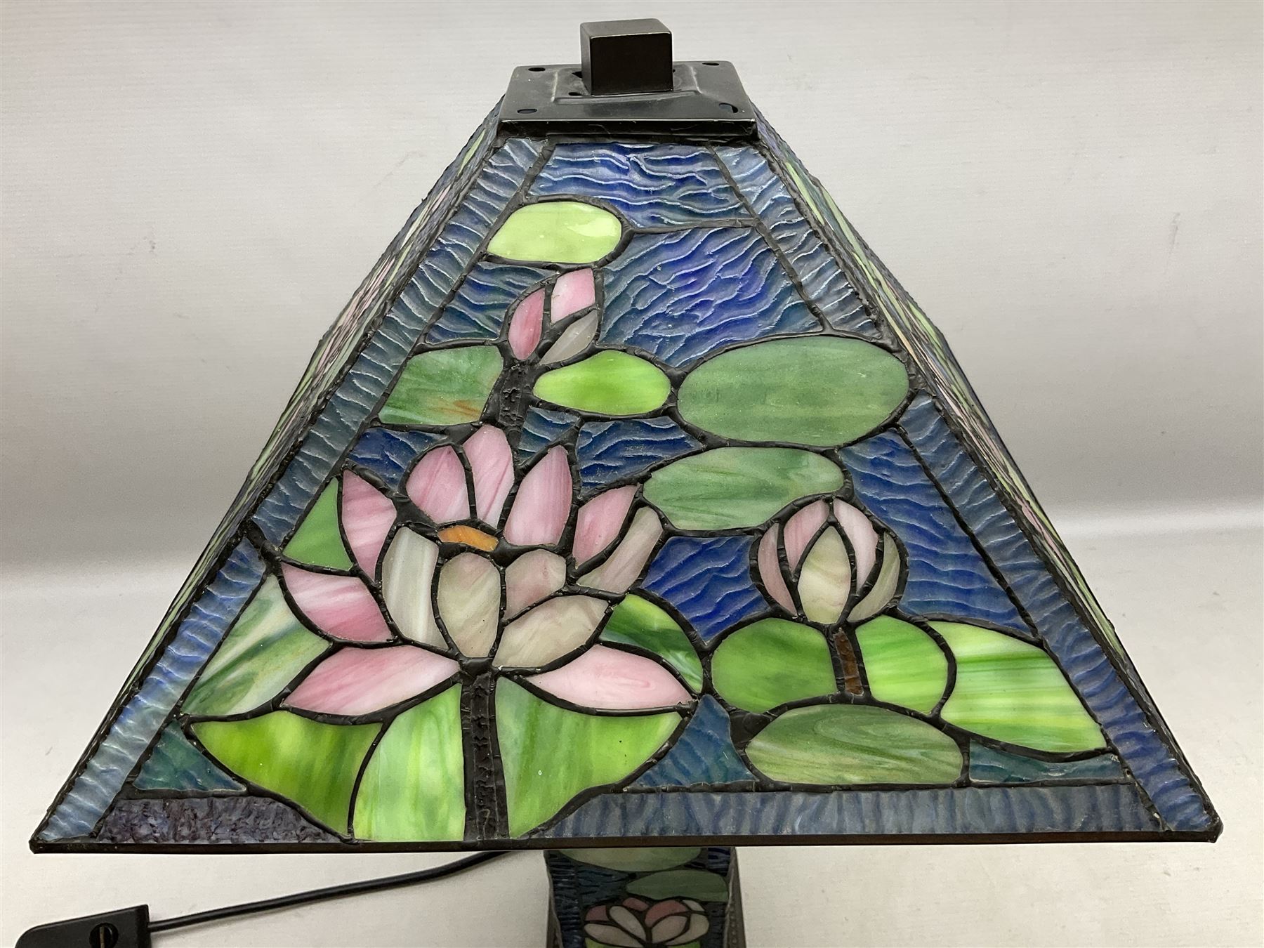 Tiffany Pond Lily style table lamp and shade with leaded panels of green, pink and rippled blue water effect ground, raised upon brushed metal base, H50cm