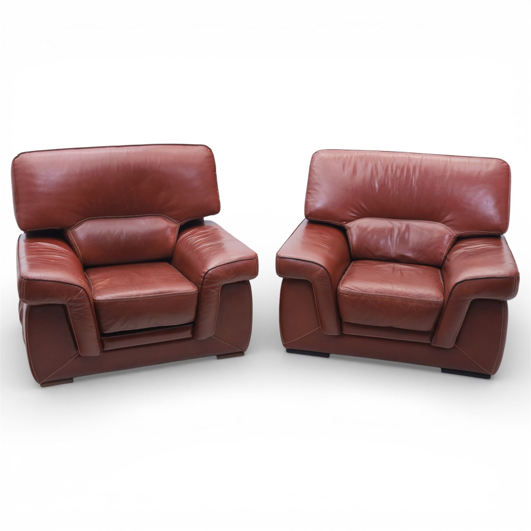 Fabrizio Mantellassi - 20th century Italian red leather suite, one three seat and two large armchairs, upholstered in deep red hide with stitched seam detailing, with magazine pockets to each side, the rectangular back cushions above broad padded arms and seat cushions, raised on low block bases

Sofa: H c98m, W 203cm, D 92cm
Armchair: H 98cm, W 113cm, D 92cm