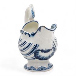 18th century Derby blue butter boat, circa 1770, of helmet form, moulded with shells and dolphin lip, on pedestal foot, H8.5cm x L9.5cm 