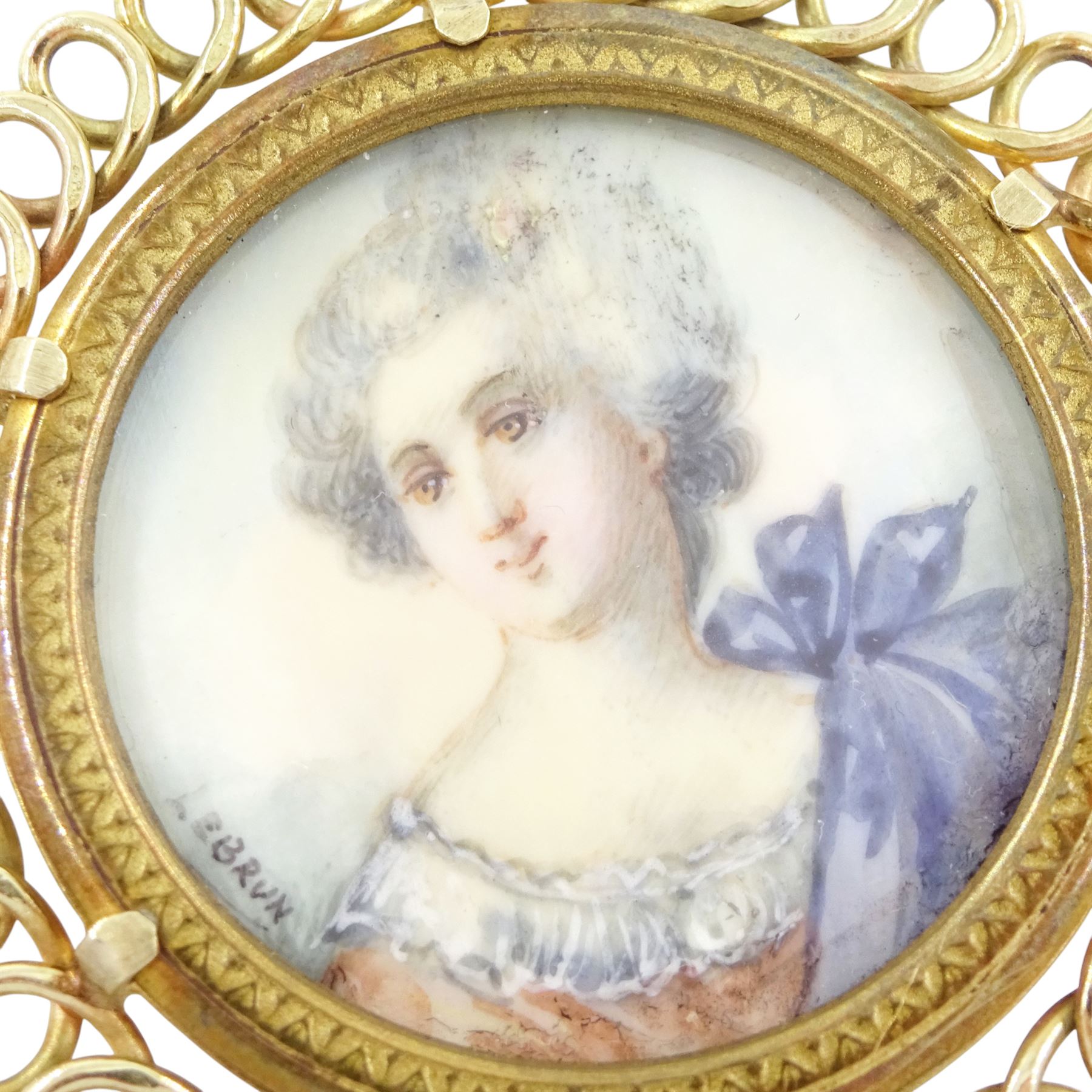 14ct gold portrait pendant, set with a circular miniature of a woman after Elisabeth Vigee Le Brun (French 1755-1842) on ivory, signed Le Brun, under a glazed panel, within a pierced scroll frame. This lot has been registered for sale under Section 10 of the APHA Ivory Act