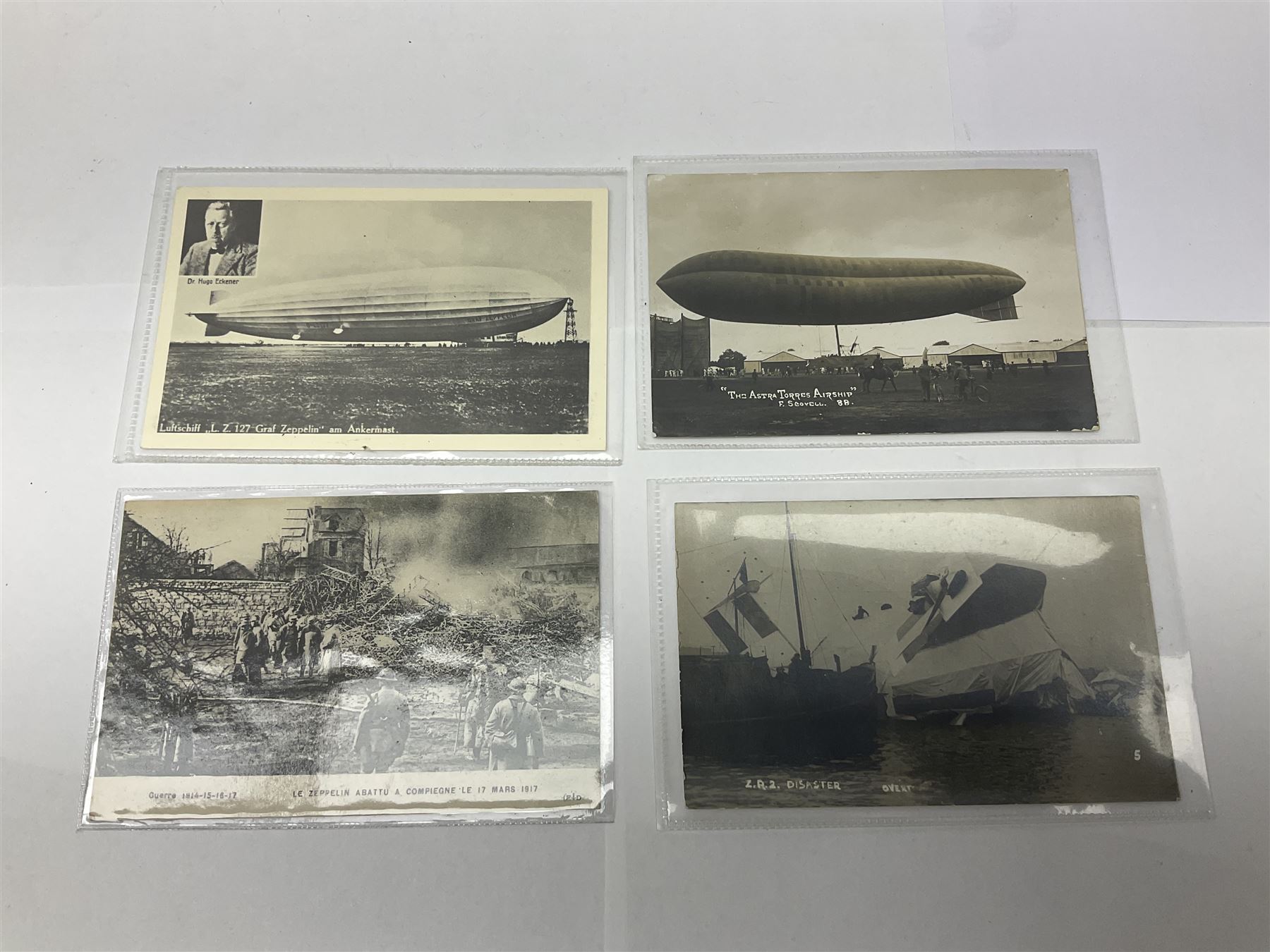 Collection of twenty six postcards depicting Airships/Zeppelins, including two pairs depicting the tragedy of the R.38. wrecked over Hull August 24th 1992, many unused.