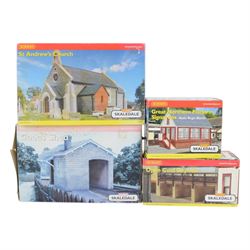 Fourteen Hornby Skaledale 00 gauge model railway trackside buildings, comprising R8718 Lower Skaledale Shelter, R9722 Bay Terrace House, R8635 Goods Shed, R9639 Great Northern Skale Regis Water Tower, R8634 Open Coal Deposit, R8633 Covered Coal Shed, R8628 Main Station Building, R8746 Canal Boat, R8976 Yew Tree Cottage, R8641 Platform Footbridge, R8602 Home Farm Barn, R9634 Great Northern Platform Signal Box, R8700 St Andrews Church and R9635 Great Northern Signal Box, all boxed