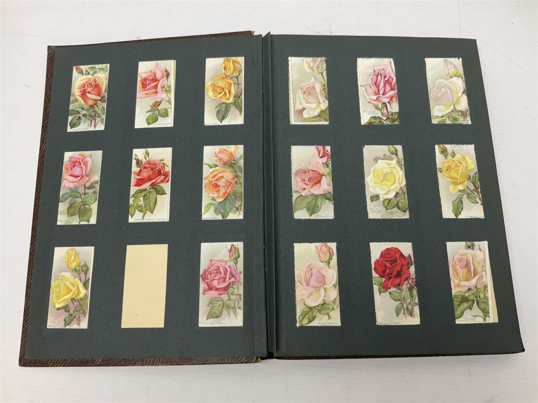 Early 20th century ephemera, to include signed photographs of Charles Boyer and Walter Pidgeon etc, a printed letter from Winston Churchill, two albums and a quantity of transfer books of Players and similar cigarette cards, including Boy Scout and Girl Guide Patrol Signs and Emblems and RAF Badges, a collection of greetings cards and postcards, a photograph album containing black and white photographs of Caius College Cambridge and guides and pamphlets on travelling Switzerland and the UK