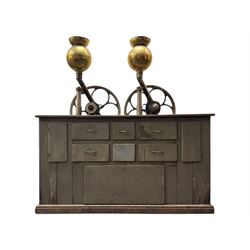 Cabinet with multiple drawers and cupboards mounted with two industrial coffee grinders with large flywheels and brass coffee reservoirs, early 20th century 