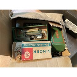 Two Singer sewing machines, model numbers 527 and 457, together with various Singer sewing machine parts, and a selection of sewing related accessories, to include threads, sewing needles, etc.