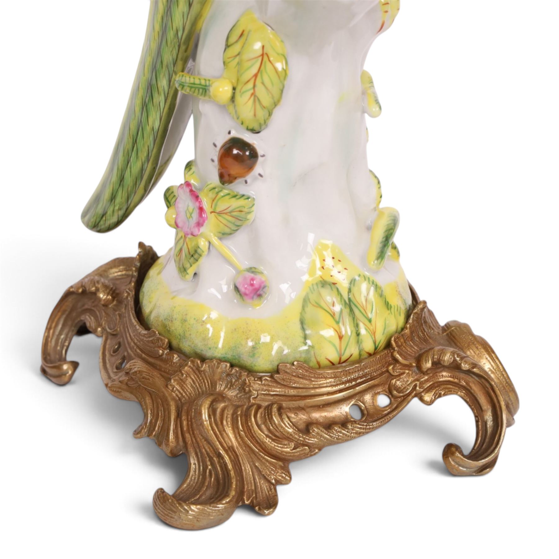 Pair of candlesticks, modelled as green parrot upon a flowering branch, upon four gilt acanthus leaf feet, H36cm
