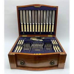 Late 19th/early 20th century composite canteen of silver flatware, contained within an early 20th century mahogany serpentine fronted case with twin drop carry handles, and hinged cover with boxwood stringing and central inlaid shell motif, above a single drawer with twin ring handles and Wellington style locking system, the cover and drawer opening to reveal plaque for Spink & Sons Ltd London, and fitted interior containing ivory handled knives, ivory handled carving set, and silver Hanoverian and Old English pattern cutlery, each with engraved monogram to terminal, hallmarked London, makers Spink & Son (John Marshall Spink), Goldsmiths & Silversmiths Co, and Chawner & Co (George William Adams), various dates ranging 1880-1923, gross weighable silver 92.59 ozt (2880 grams)