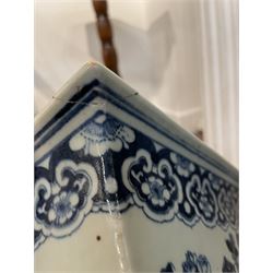 19th century Chinese blue and white planter and stand, each of square slightly tapering and flared form, the planter decorated with figures and precious objects between stylised foliate borders, the stand decorated with landscapes beneath a lipped rim with cell band, planter H28cm D25.5cm, stand H7cm D26cm