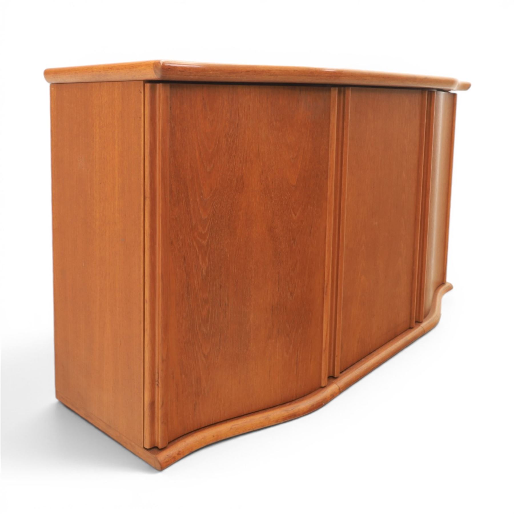 Skovby - model '400T' teak sideboard, shaped top above three cupboard doors with recessed handles, fitted with shelving and drawers