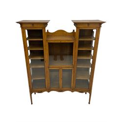 Early 20th century oak drop centre display cabinet, enclosed by glazed doors 
