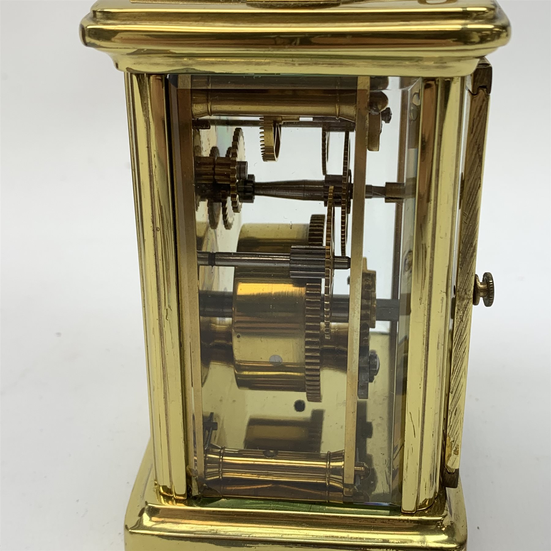 A brass cased carriage clock, the white enamel dial with black Roman numerals, marked Pearch & Sons Leeds, York & Leicester, including handle H14cm, in fitted case. 