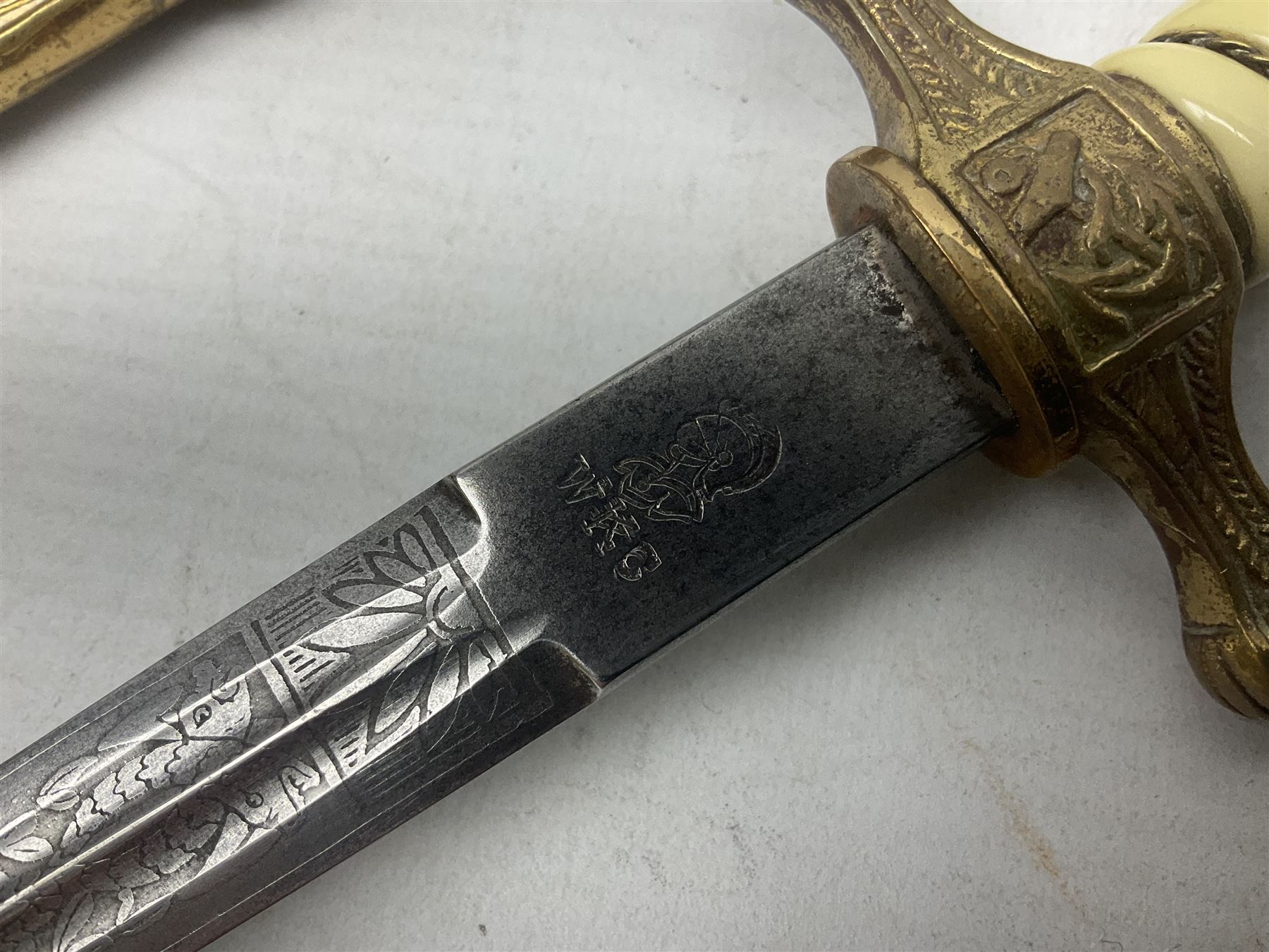 WW2 German kreigsmarine style dagger composed from various age parts, the post-war 25cm double fullered blade  with etched decoration and inscribed WKC with knight's head; in gilt brass scabbard with two rings L42cm overall