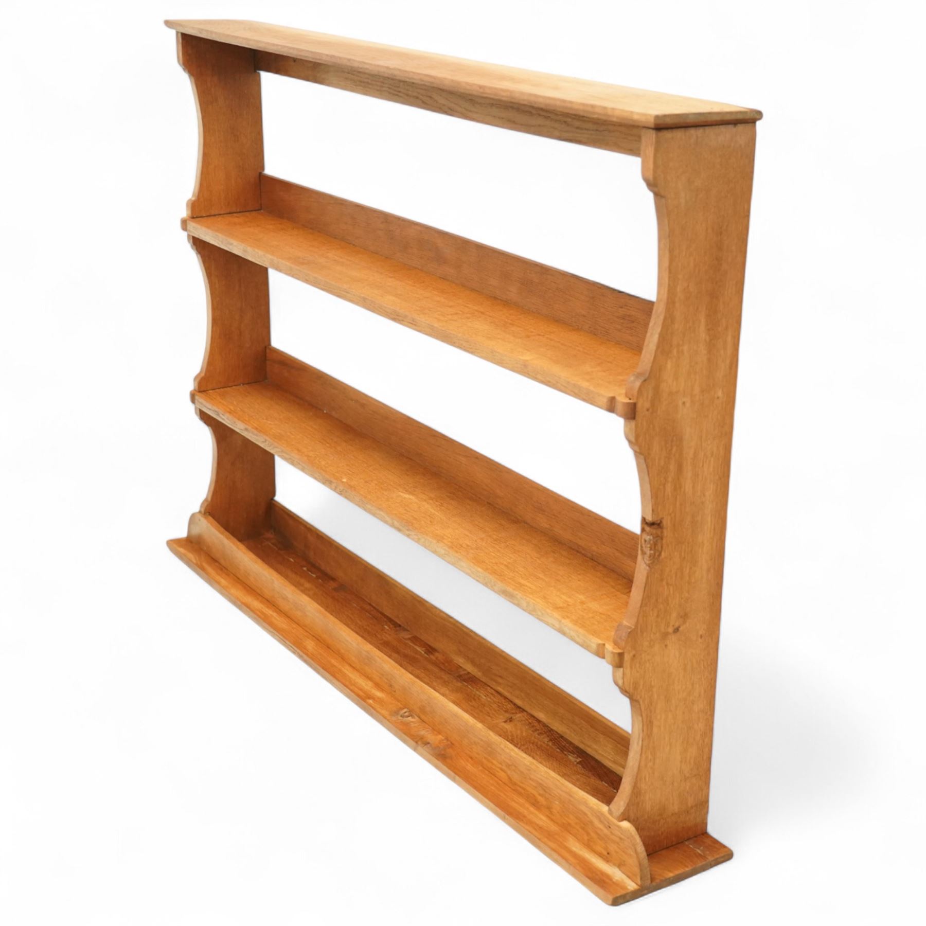 Gnomeman - oak plate rack, rectangular moulded top over three open plate shelves with raised front rails, shaped and chamfered upright supports, stepped base plinth, signature carved Gnome by Thomas Whittaker of Littlebeck